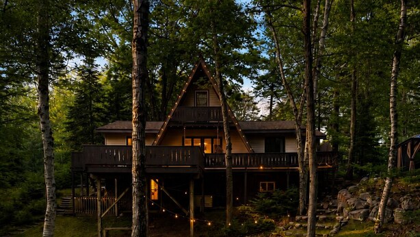 A cabin with a fire pit and outdoor seating. - A Frame - Walk to Beach - Hot Tub (Ellsworth)