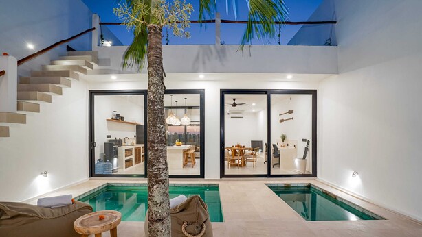 A modern home with a pool, a staircase, and a dining area. - Villa Flambard (Canggu)
