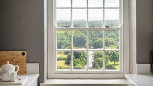 A window with a view of a green landscape and a river. - Maison Cottage -  a cottage that sleeps 4 guests  in 2 bedrooms (Richmond)