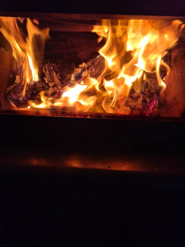 A close-up of a fire burning in a fireplace.
