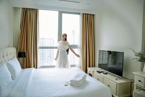 Relax in comfort with a large bed, flat-screen TV, and city views.