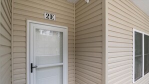 A beige exterior wall with a white door and a window. - Sierra Bay Sweet Retreat - Two Pools & More! (Camdenton)