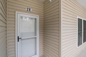 A beige exterior wall with a white door and a window. - Sierra Bay Sweet Retreat - Two Pools & More! (Camdenton)