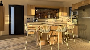 A modern kitchen with a central island, bar stools, and built-in appliances. - Villa Eclats Panoramiques (Saint-Pierre)