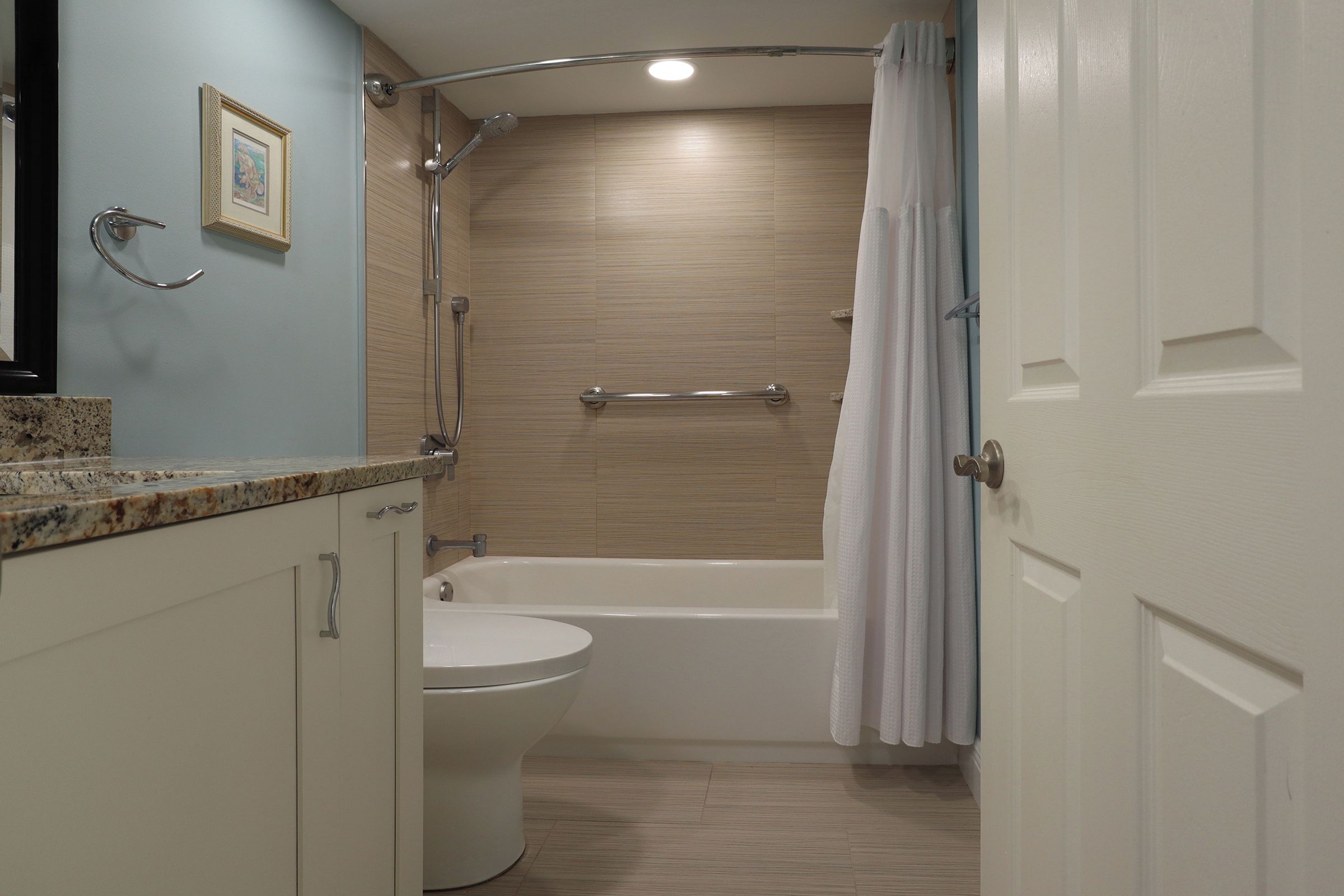 Une salle de bain avec douche, toilettes et baignoire.