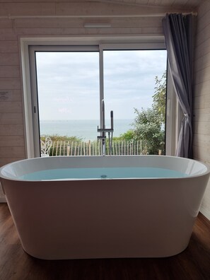 Jetted tub, hair dryer, towels, soap