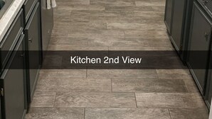 A kitchen with dark cabinets, a marble countertop, a wooden bench, and a large window with blinds. - AggieLand Vacation House!  Charming 3-BR 2-BA only 3 miles from Texas A&M Campus (Bryan)
