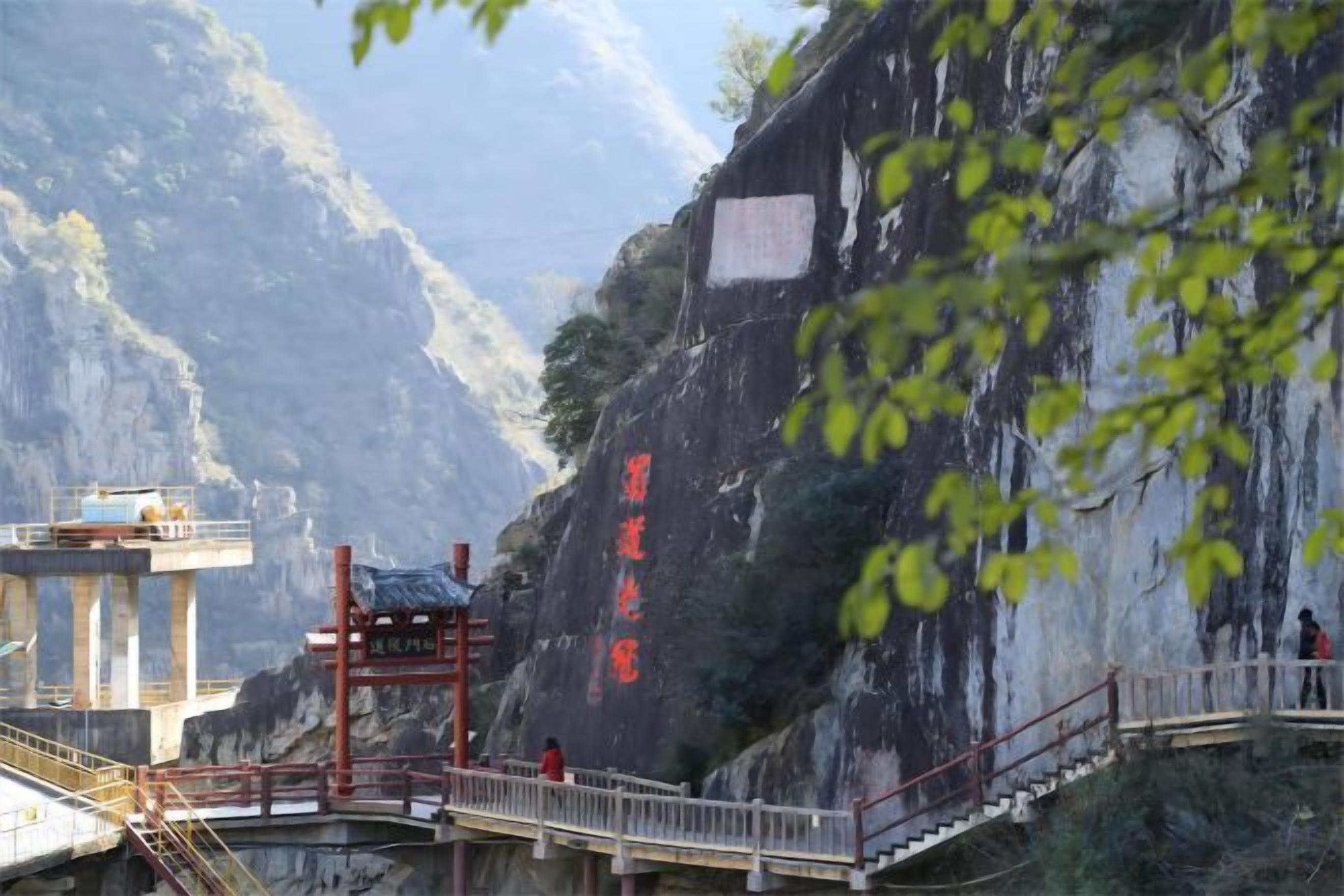 A mountainous landscape with a bridge and a viewing platform.