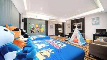 A hotel room with two beds, a TV, a desk, and a tent.