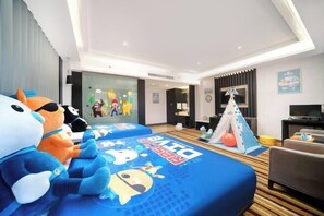 A hotel room with two beds, a TV, a desk, and a tent.