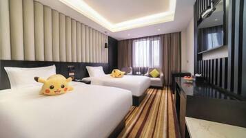 A hotel room with two beds, a flat-screen TV, a minibar, and a large window with curtains.