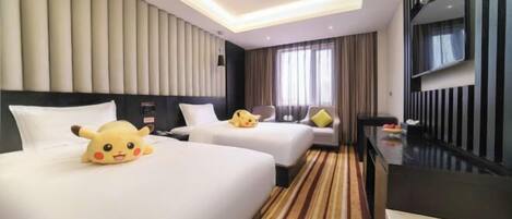 A hotel room with two beds, a flat-screen TV, a minibar, and a large window with curtains.
