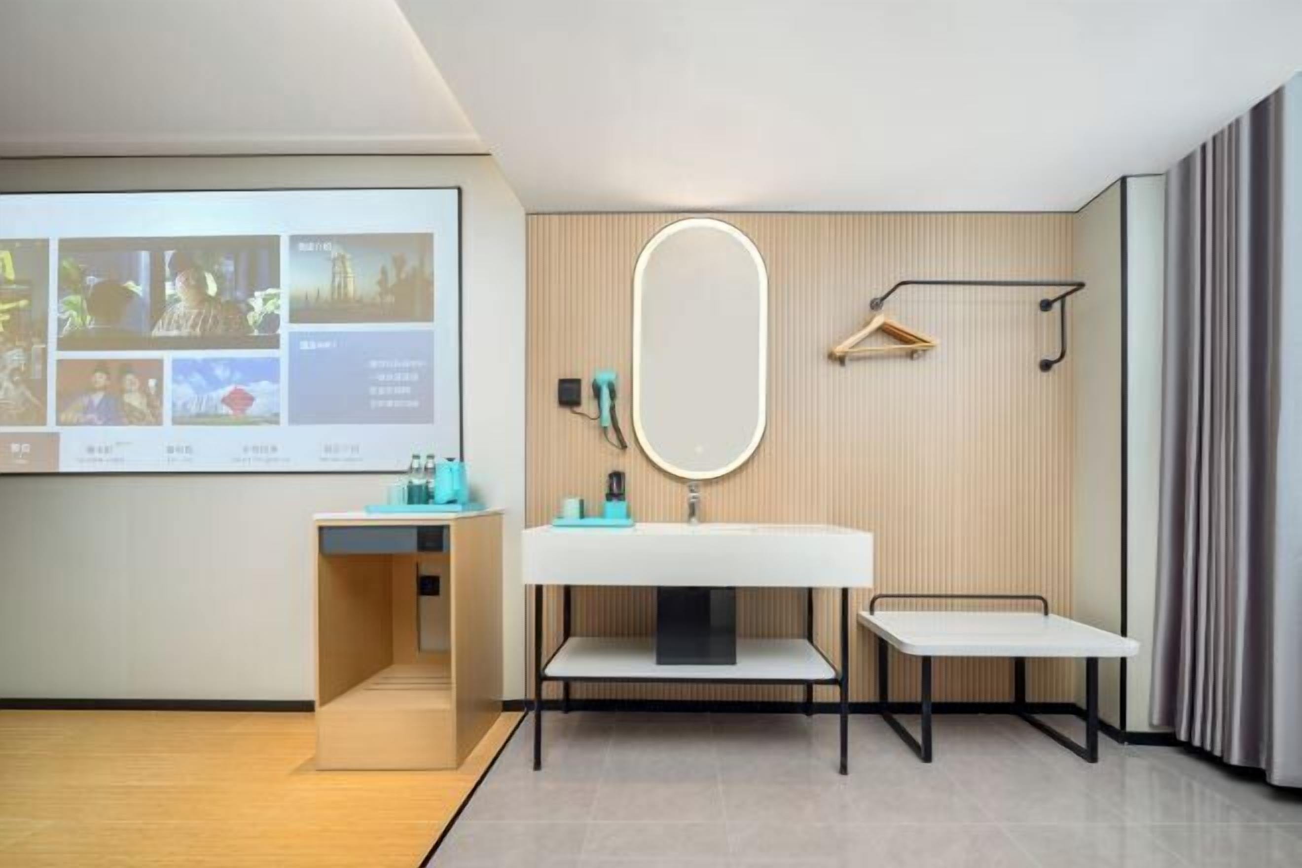 A modern bathroom with a white sink, mirror, and towel rack.