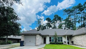 A two-story house with a garage, a front lawn, and a driveway. - Beech St. fenced back yard, central location, garage (Covington)