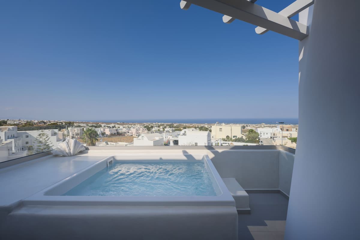 A rooftop pool with a clear view of the sea and surrounding buildings.