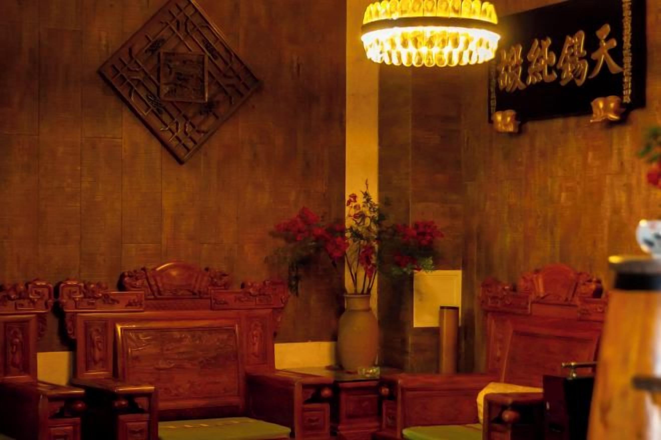 A traditional room with wooden furniture and a chandelier.