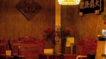 A traditional room with wooden furniture and a chandelier.