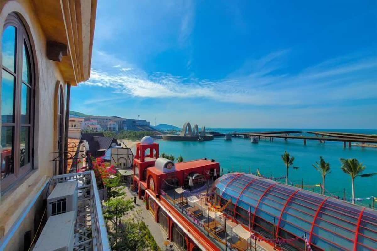 A hotel with a view of a coastal area, including a bridge and water.