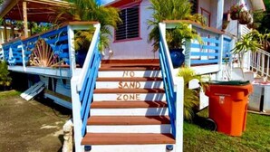 A staircase leading to a house with a 'No Sand Zone' sign. - Ocean front 2-bedroom house private Beach, pool in enchanting Rincon wifi AC (Rincon)