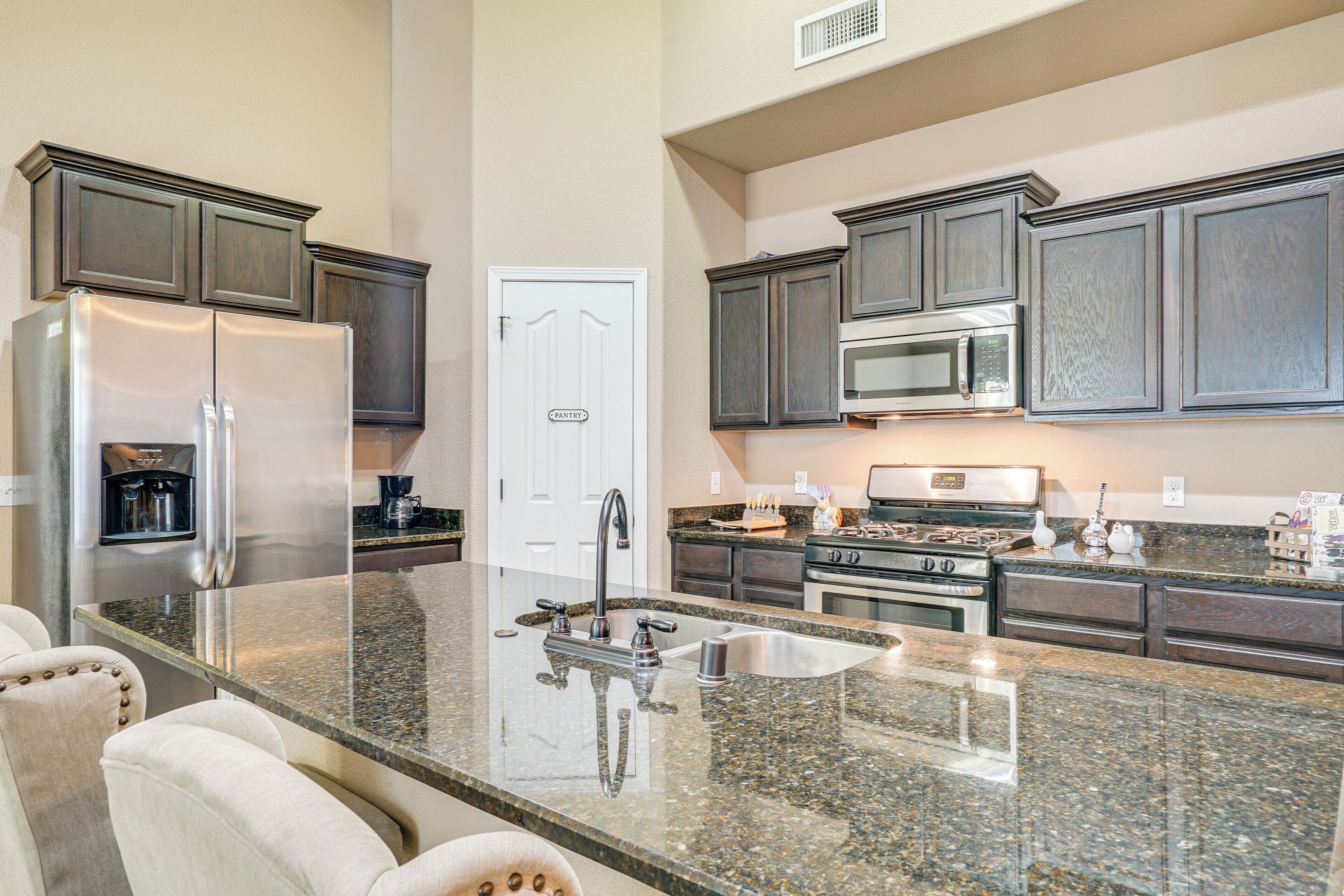 Coffee/tea maker, toaster, cookware/dishes/utensils, dining tables