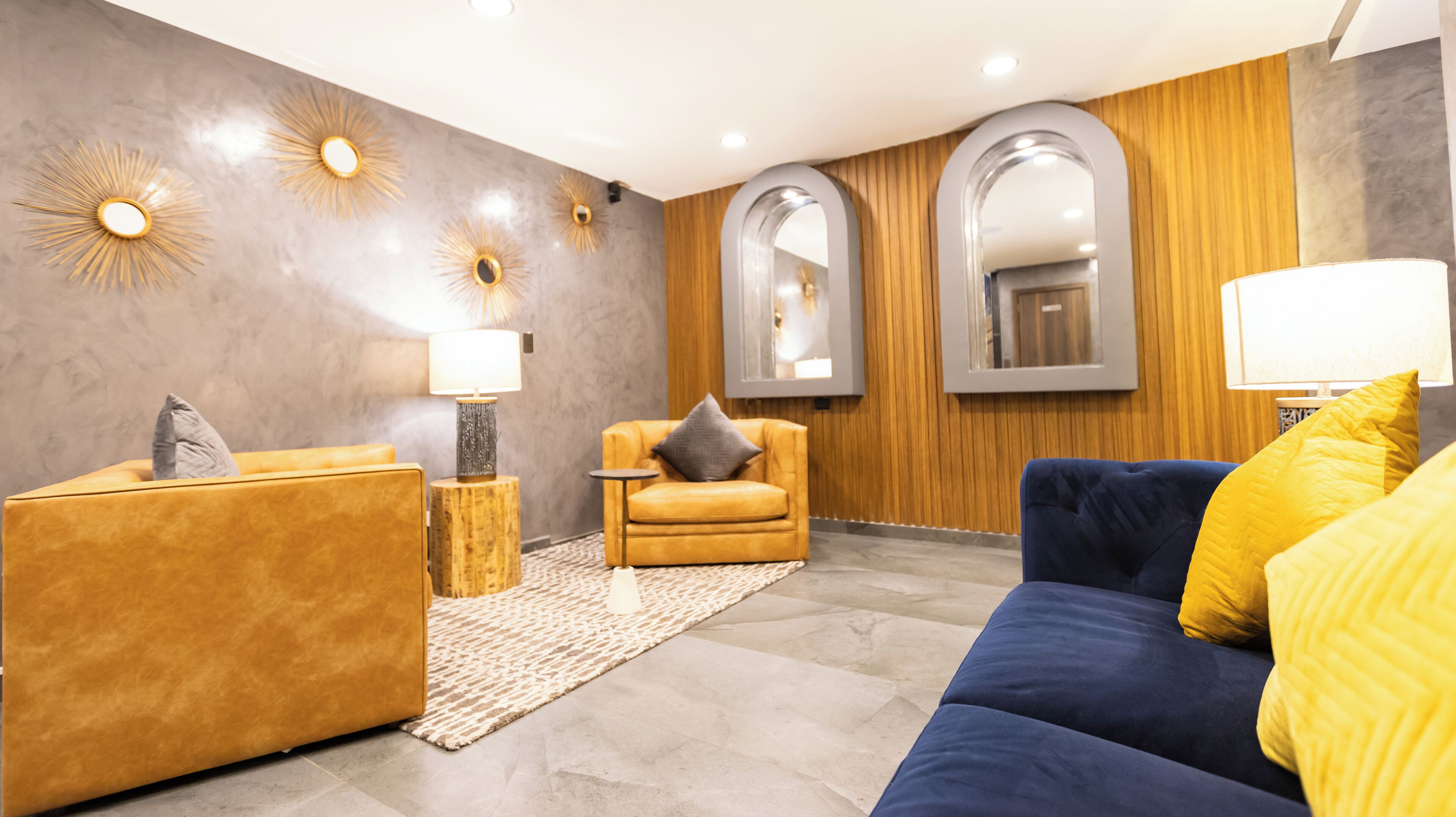 A modern living room with a sofa, armchair, and a coffee table.