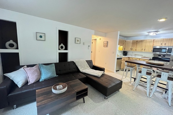 Open living space with comfy seating, smart TV, and mountain charm.