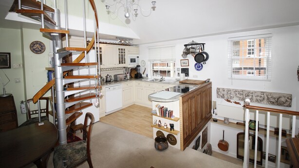 A spacious kitchen with a central island, wooden staircase, and a chandelier. - beautiful central London duplex apartment007 (London)