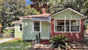 A two-story house with a green front and a red brick section. - 2B1BA  Central - Airport, Riverside, Zoo, Beach (Jacksonville)