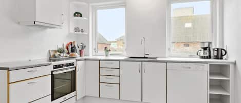Fridge, stovetop, dishwasher, coffee/tea maker