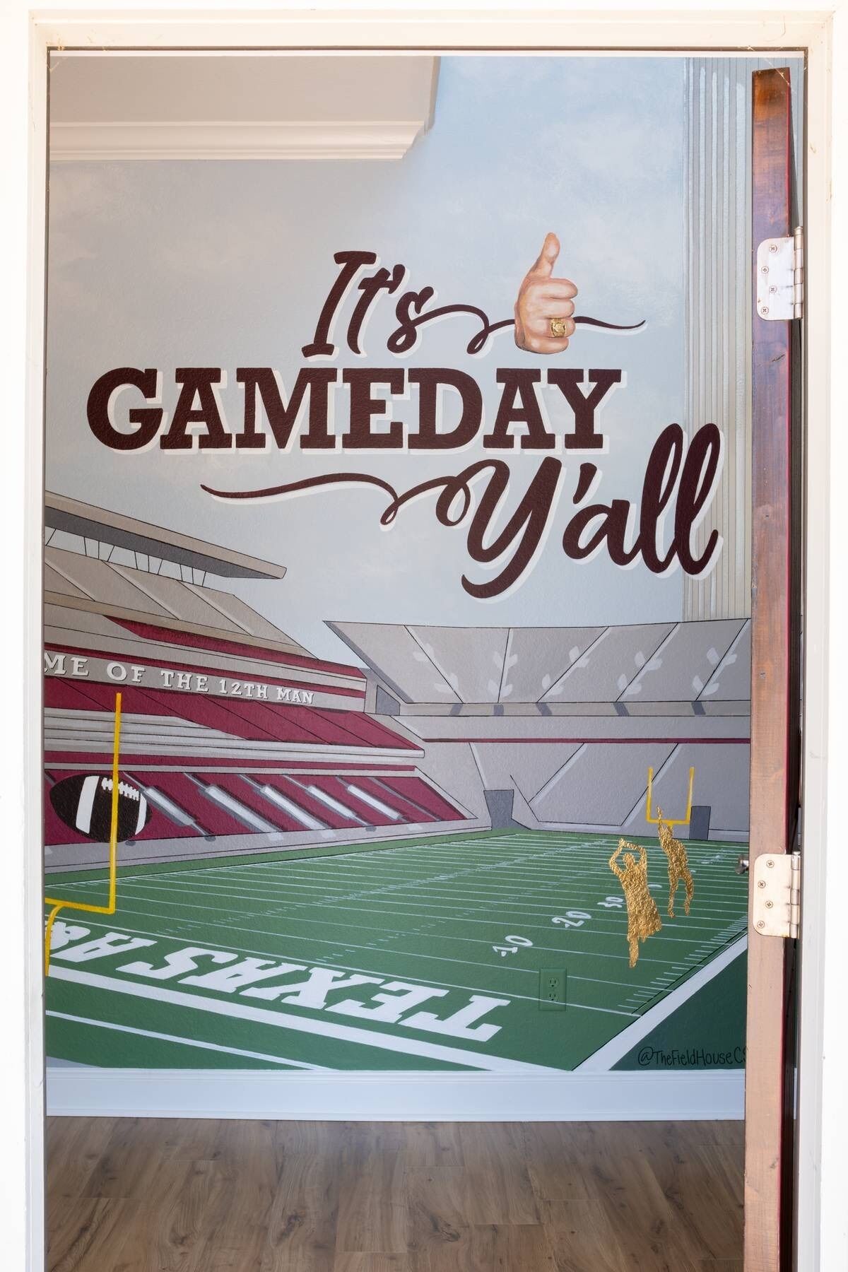 A football field mural with the text "It's GAMEDAY Y'all" and a thumbs-up.