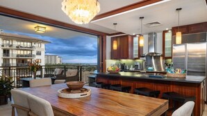 Une cuisine moderne avec un coin bar, de grandes fenêtres et une vue sur le panorama urbain.