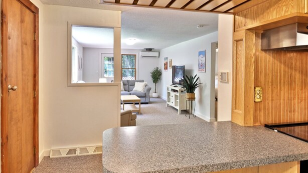 A kitchen with granite countertops, wooden cabinets, and a built-in oven.