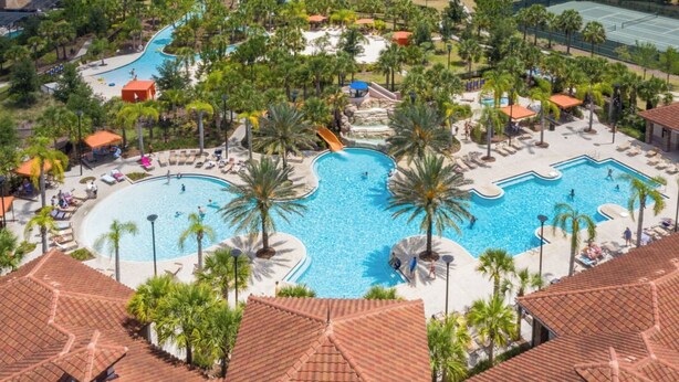 A resort with multiple swimming pools, palm trees, and a tennis court. - Spacious 5-bedroom townhome in gated community. Minutes from Disney! Sleeps 10 (Davenport)