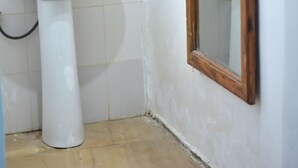 A bathroom with a white sink, a mirror, and a tiled floor. - La Neisha hotel Nungwi (Nungwi)