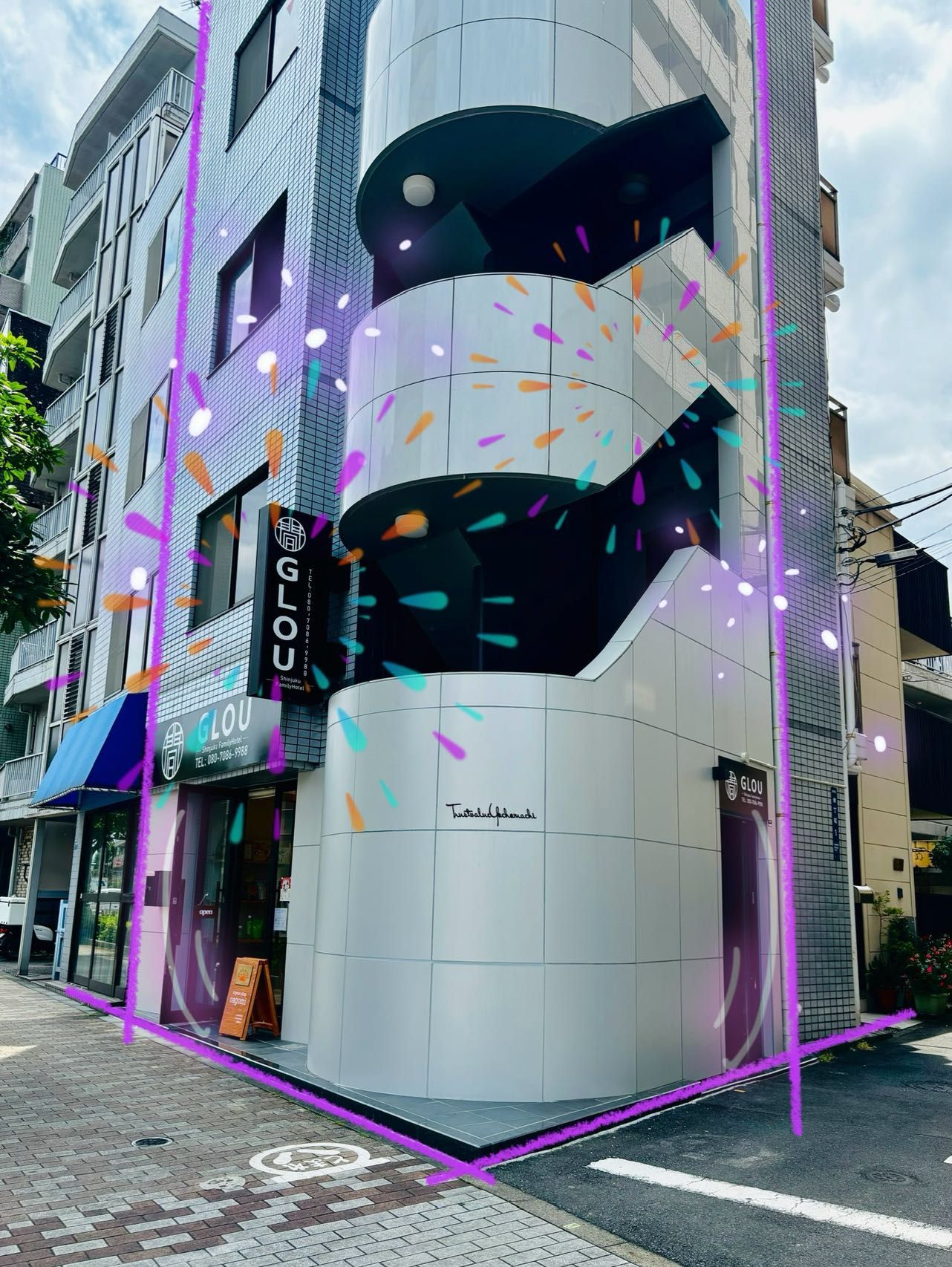 A modern building with a prominent GLOU sign, a curved glass facade, and a visible entrance.