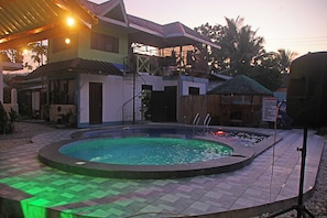 Outdoor pool, pool umbrellas, lifeguards on site