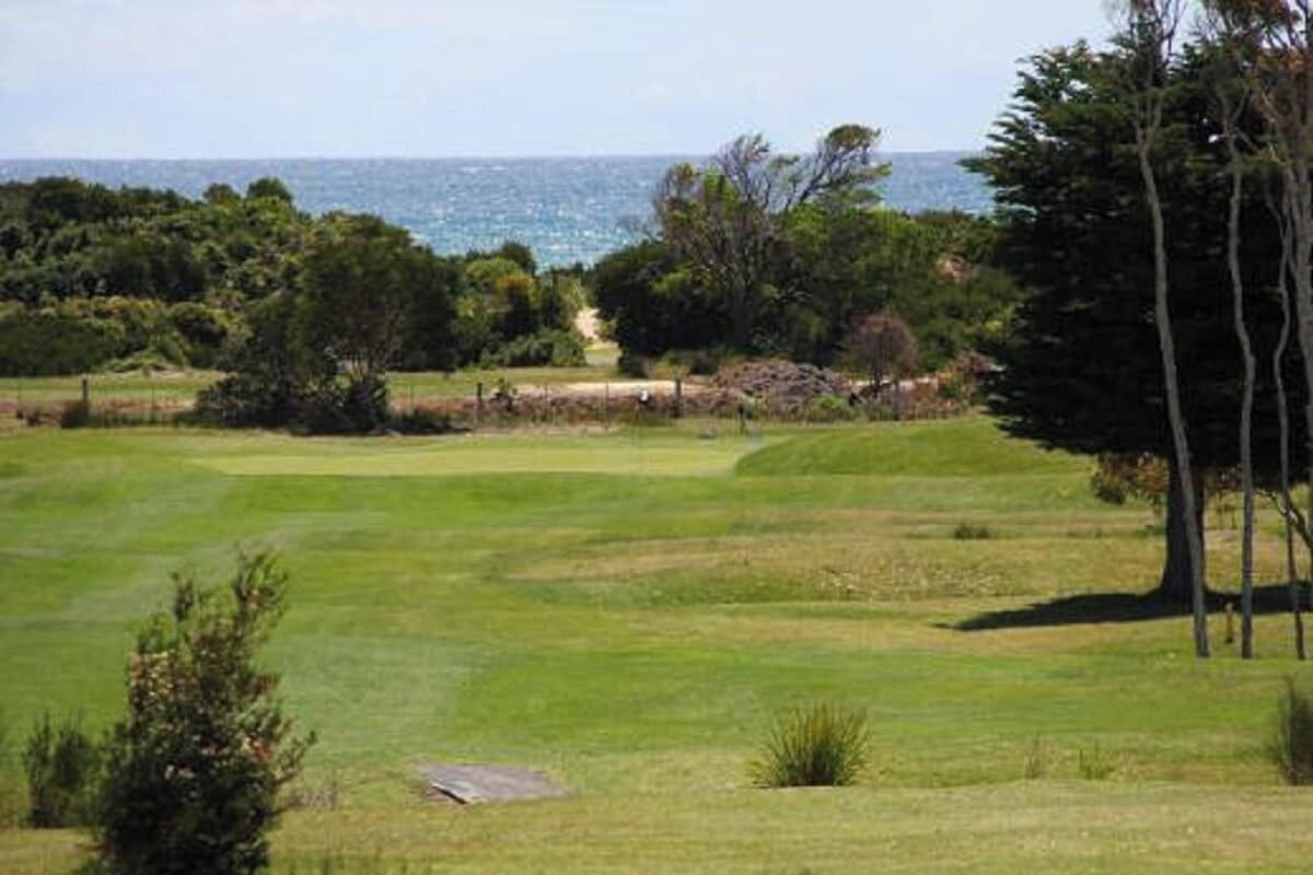 A golf course with a view of the ocean.