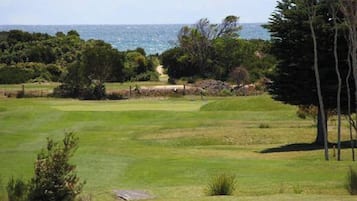 A golf course with a view of the ocean.