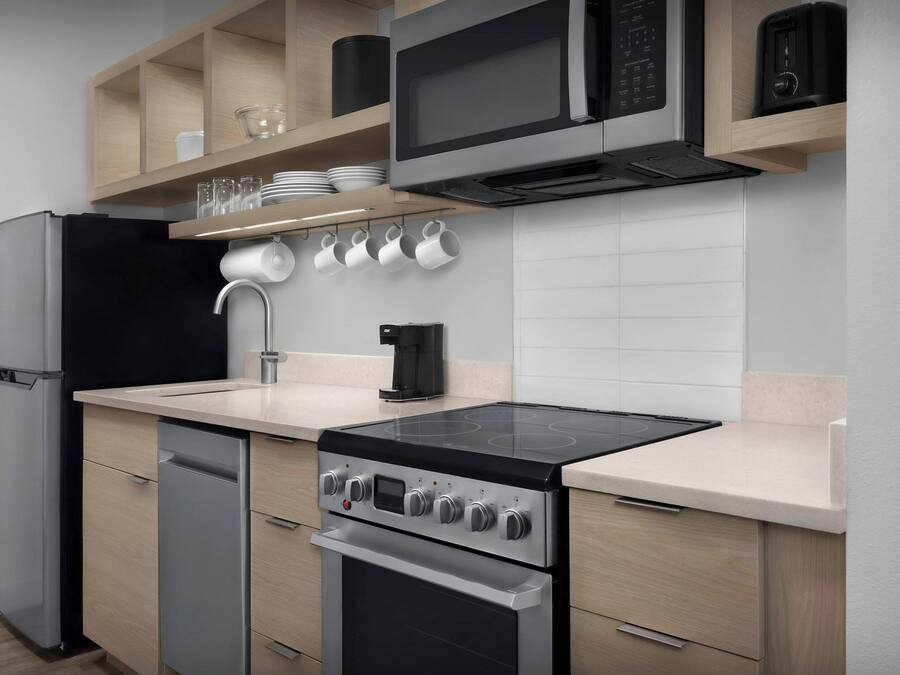 A modern kitchen with a built-in oven, microwave, and dishwasher.