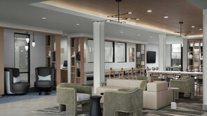 A modern hotel lobby with a seating area, a dining space, and a reception desk. - TownePlace Suites by Marriott Paris (Paris)