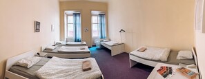 A hotel room with two single beds, a desk, a chair, and a wardrobe. - korea town (Prague)