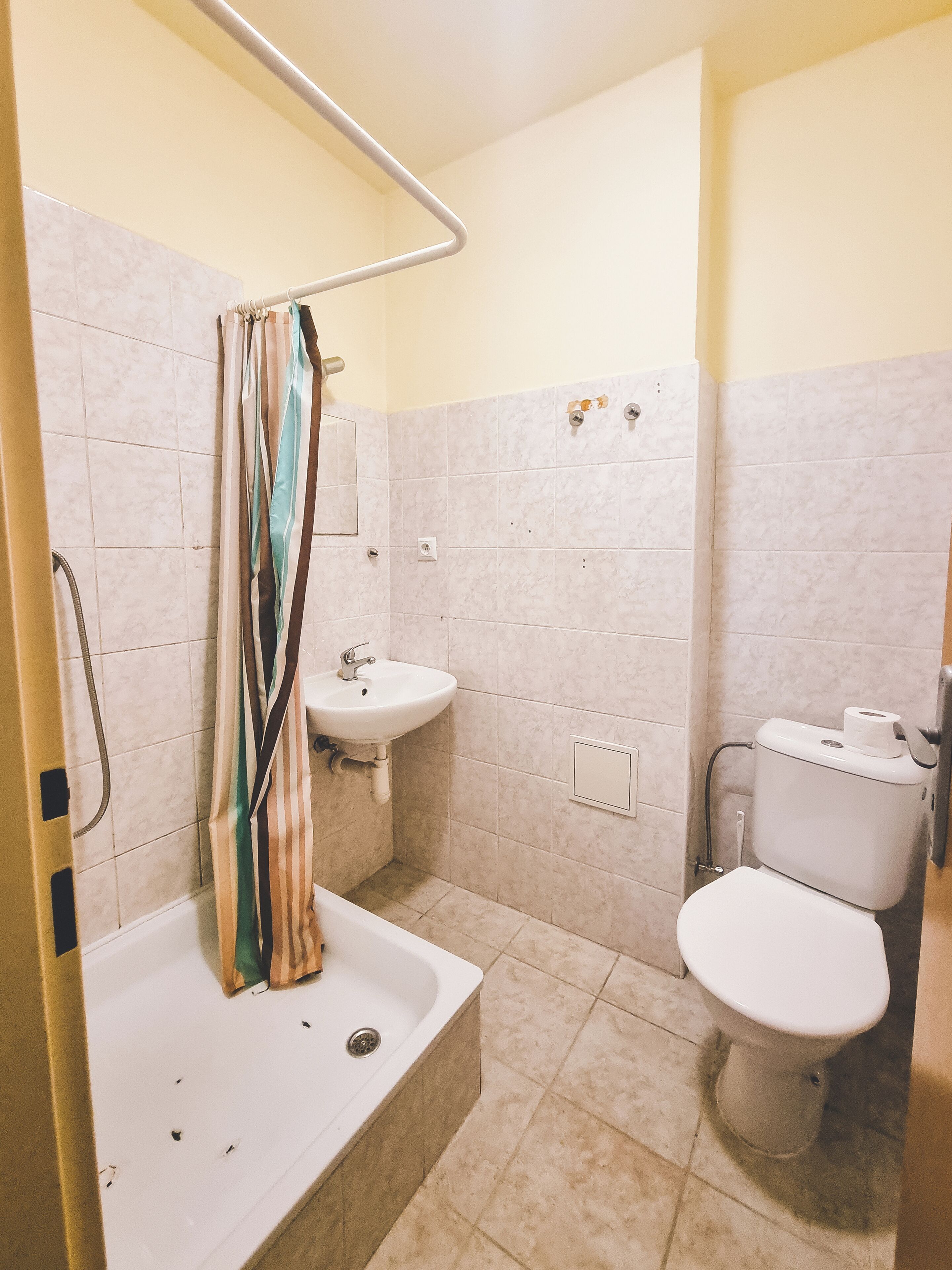 A bathroom with a bathtub, a sink, and a toilet.
