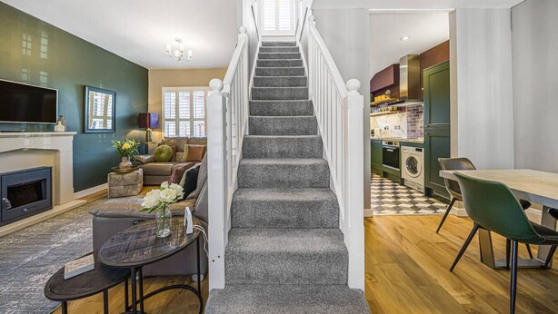 A modern home interior with a staircase leading to a dining area and kitchen. - Corner Lodge - Central, refurbished & free parking (York)