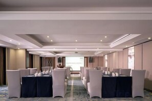 A conference room with a long table, chairs, and a projector screen. - Ming Yi Hotel (Zhuzhou)