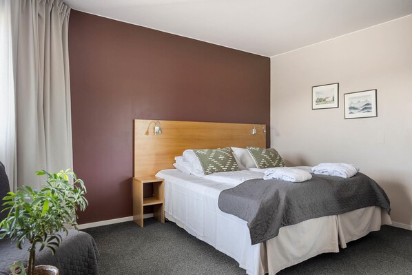 A hotel room with a bed, a bedside table, a small plant, and two framed pictures on the wall. - Sirdal Hoyfjellshotell, BW Signature Collection (Sirdal)