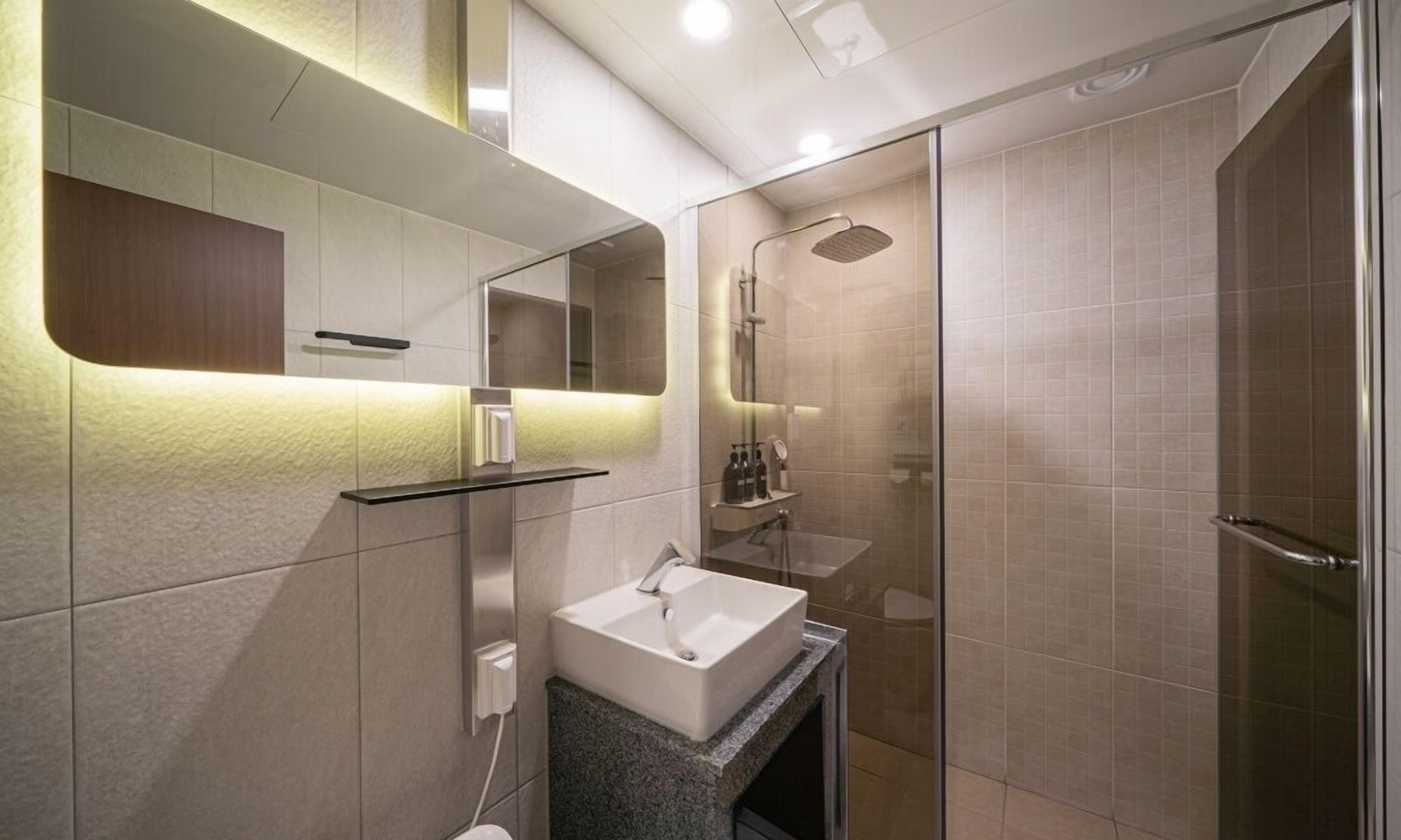 King Room | Bathroom | Shower, hair dryer, slippers, soap