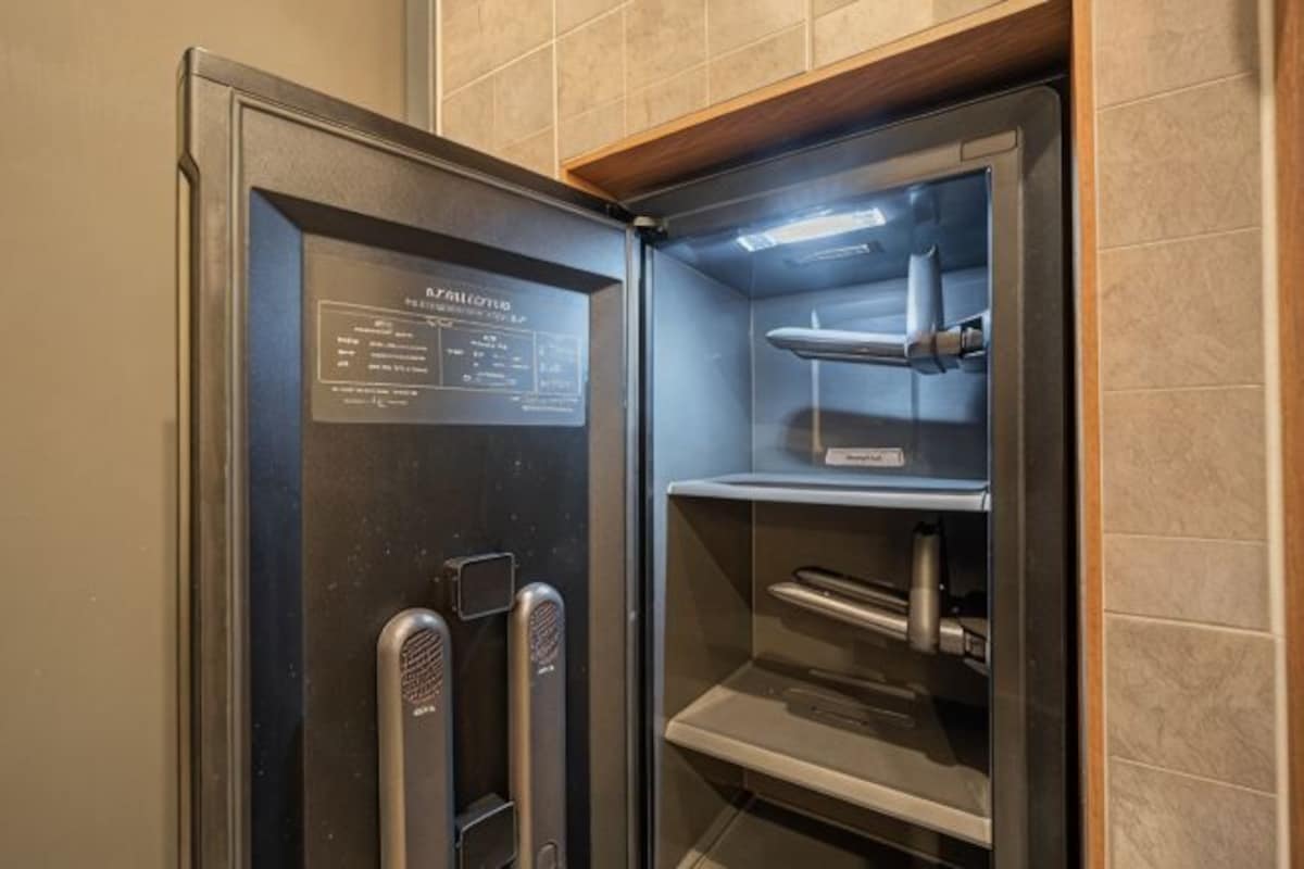A stainless steel refrigerator with a digital display, a water dispenser, and a built-in ice maker.