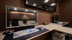 A modern hotel room with a large flat-screen TV, a desk with a keyboard and mouse, and a bed with a headboard. - Brown Dot Hotel Sangju (Sangju)