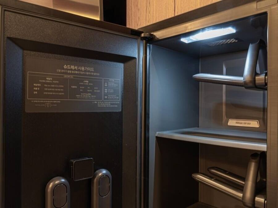 A modern, compact refrigerator with a digital display and a sleek design.