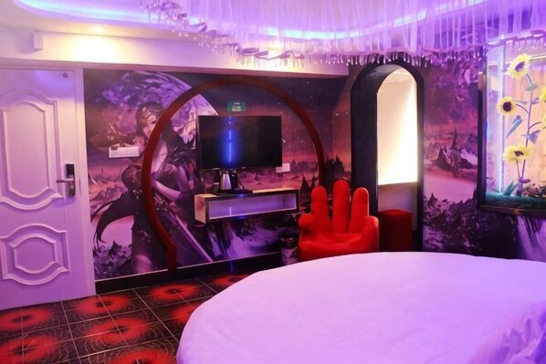 A room with a bed, a red chair, a television, and a wall with a floral mural. - Yueyi Hotel (Shanghai)